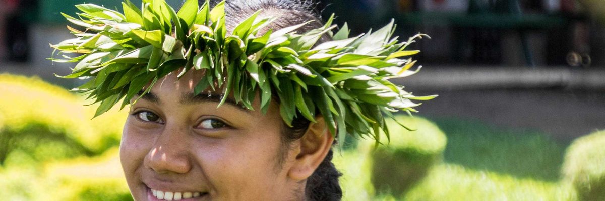 smiling woman wearing a crown of green leaves