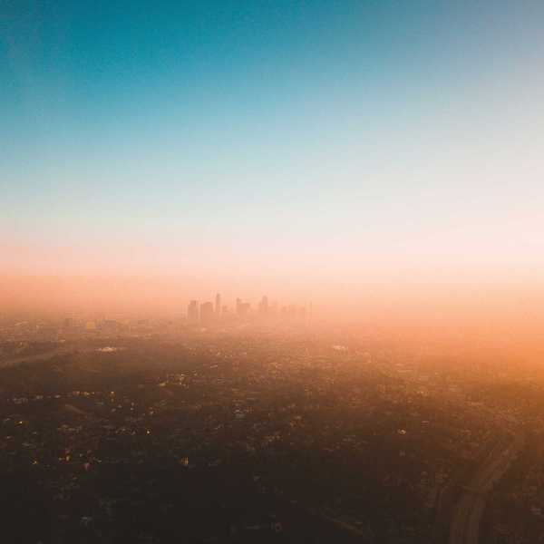 Smoggy Los Angeles skyline with skyscrapers in distance.