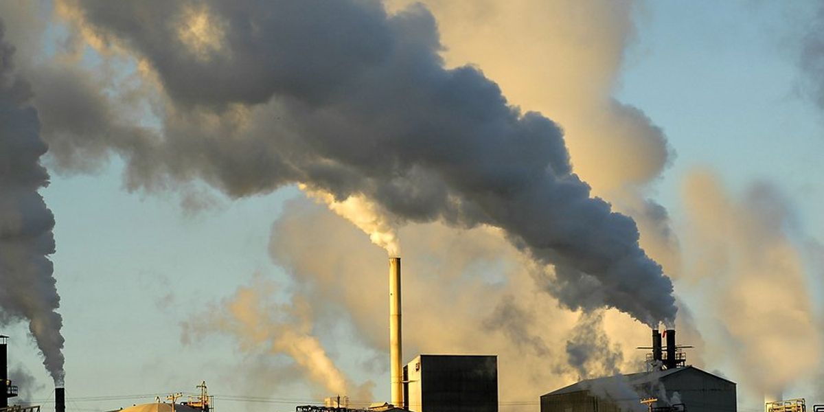 Smokestacks from a factory spewing smoke and pollution into the air.