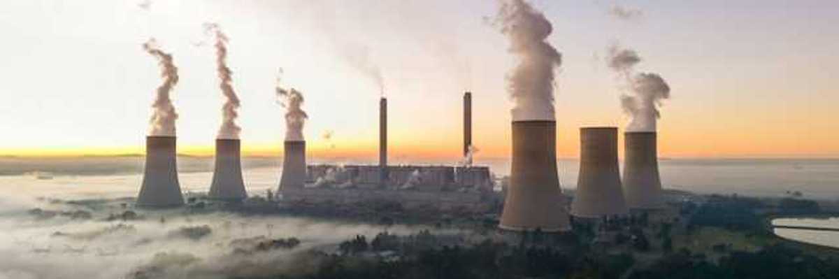 Smokstacks from a power plant emitting smoke into the air