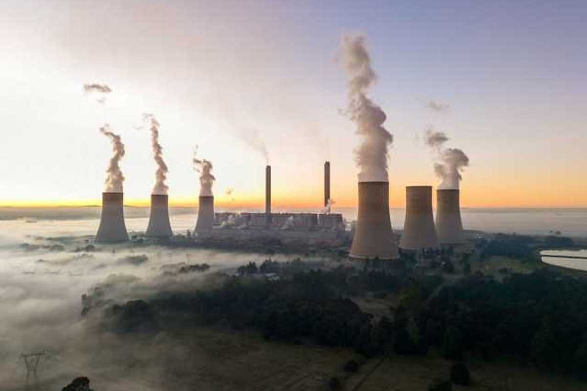 Smokstacks from a power plant emitting smoke into the air