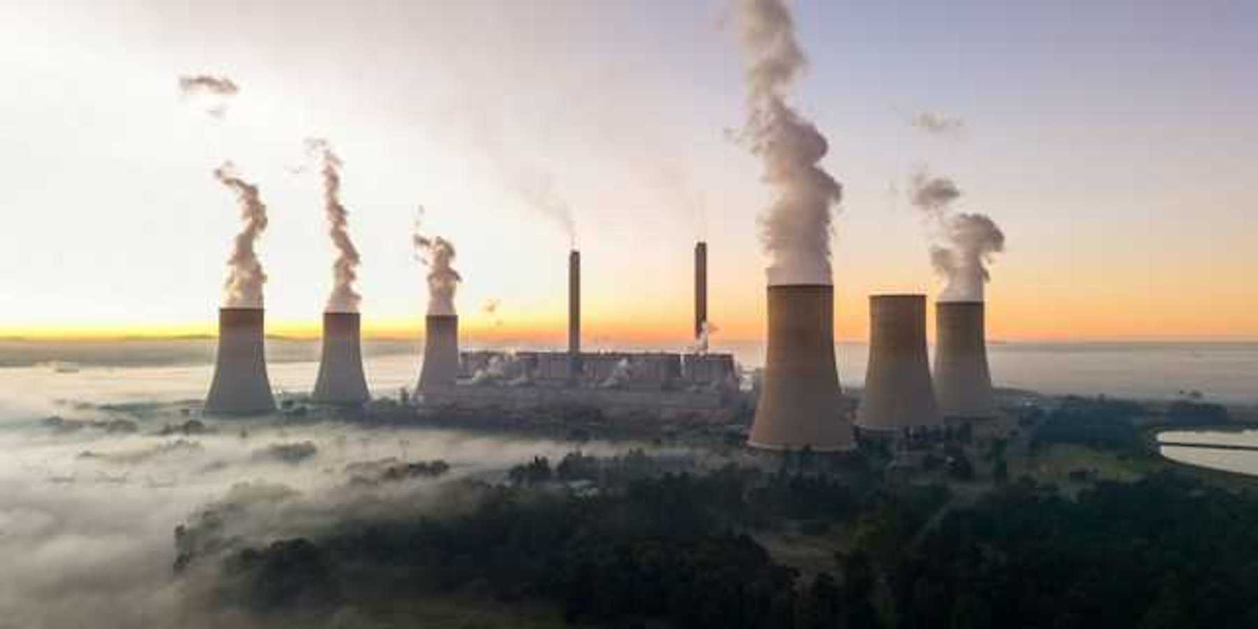 Smokstacks from a power plant emitting smoke into the air