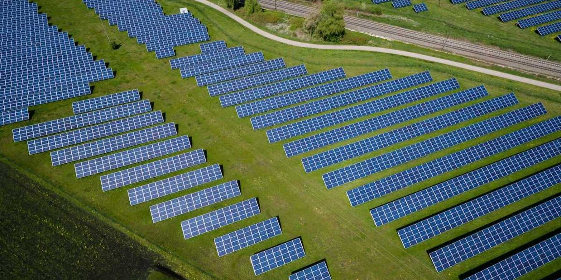 Solar farm sited in a green field adjacent to a country road