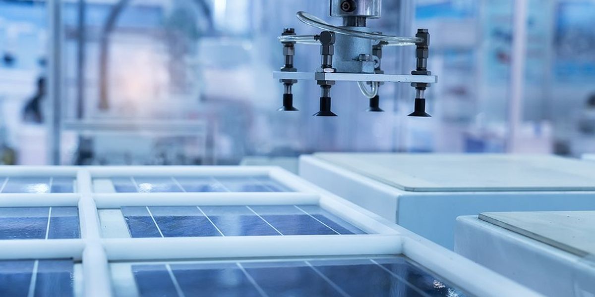 Solar panel manufacturing equipment in a high-tech factory.