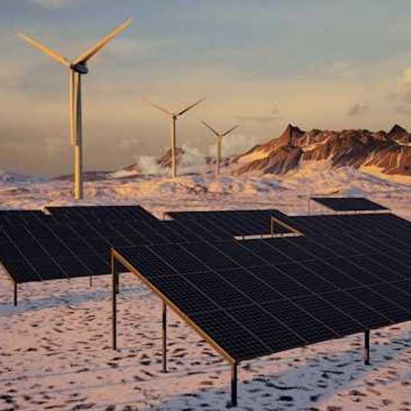 Solar panels and wind turbines in a snowy landscape