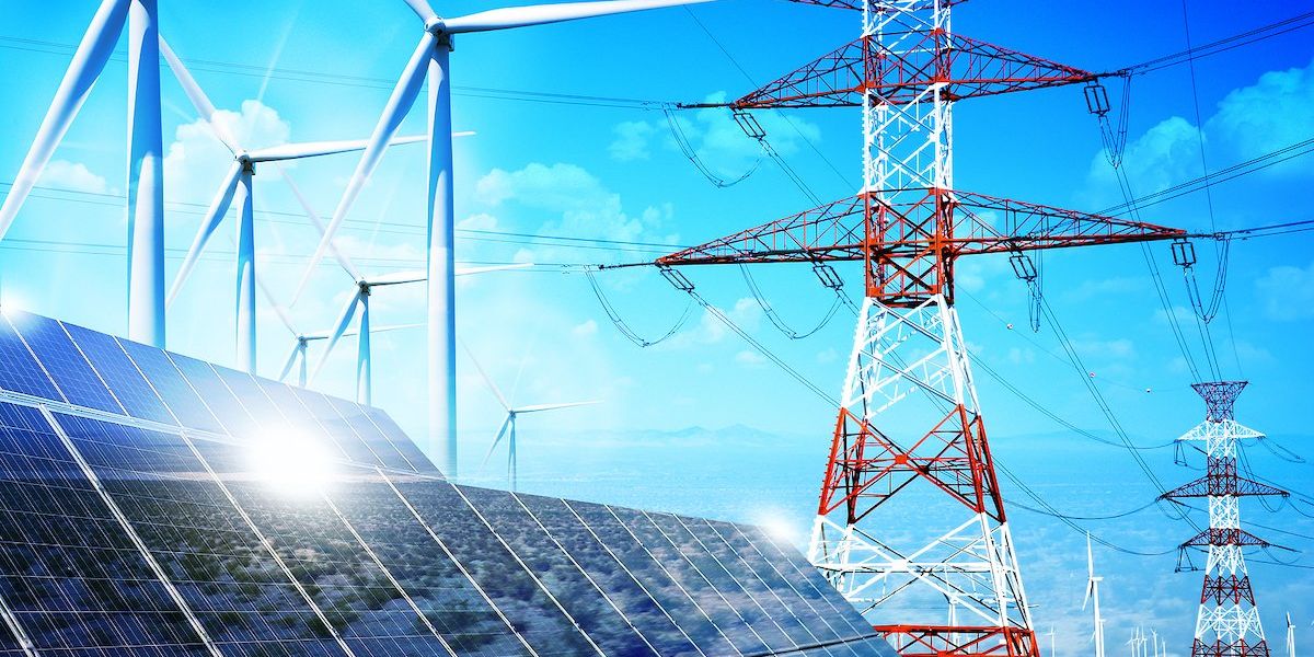 Solar panels appear in foreground, with electricity transmission lines and wind turbines in background.