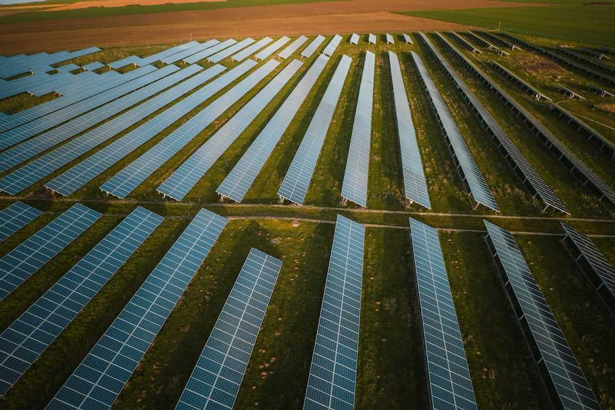 Solar panels arrayed across rural agricultural setting