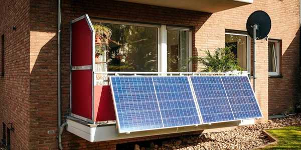 Solar panels installed on a city balcony, generating solar energy.