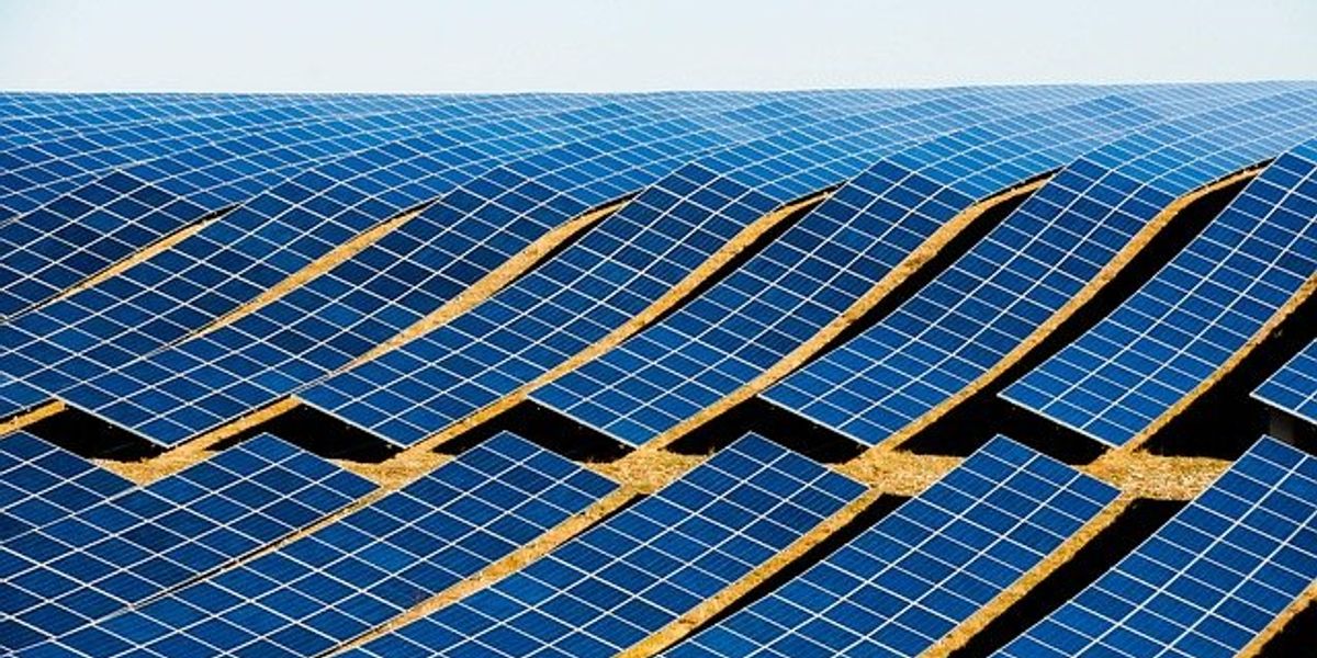 Solar panels installed on a rolling hill.