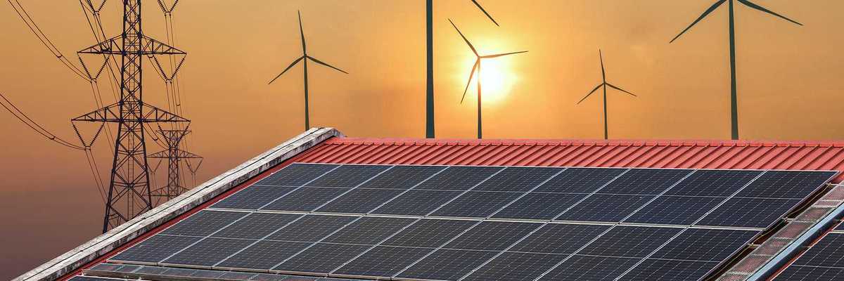Solar panels juxtaposed against transmission lines and wind turbines