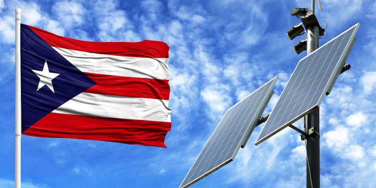 Solar panels on a background of blue sky with a flagpole and the flag of Puerto Rico