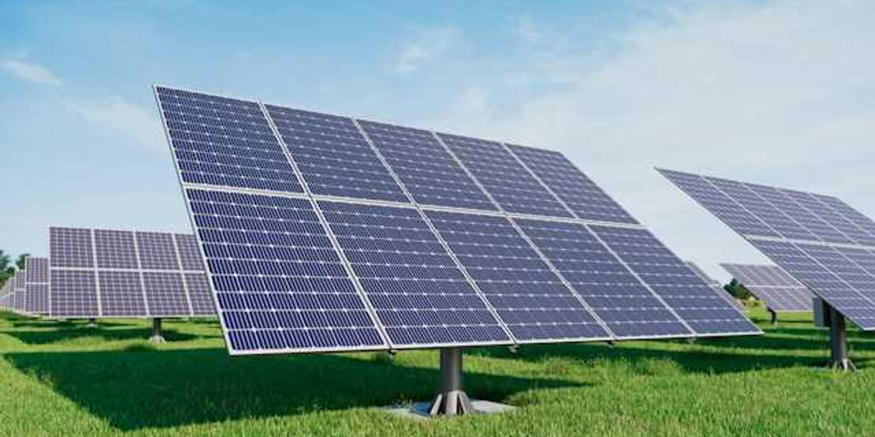 Solar panels standing in a grassy field