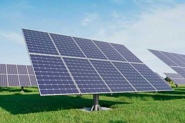 Solar panels standing in a grassy field