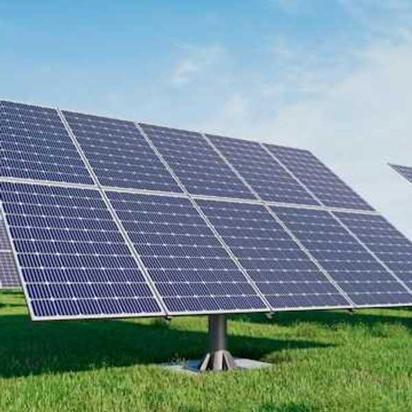 Solar panels standing in a grassy field