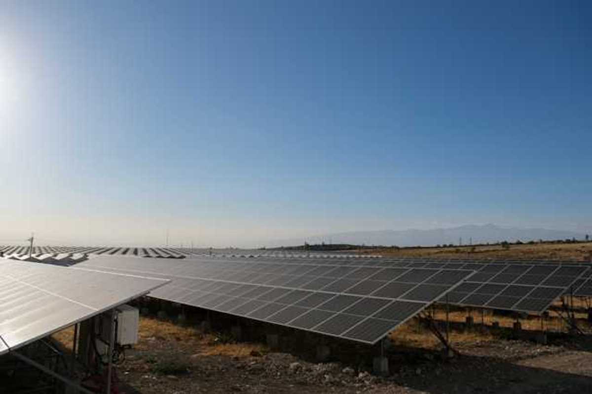 Solar panels stretched across a rocky landscape