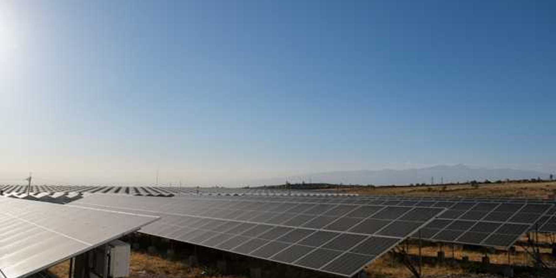 Solar panels stretched across a rocky landscape