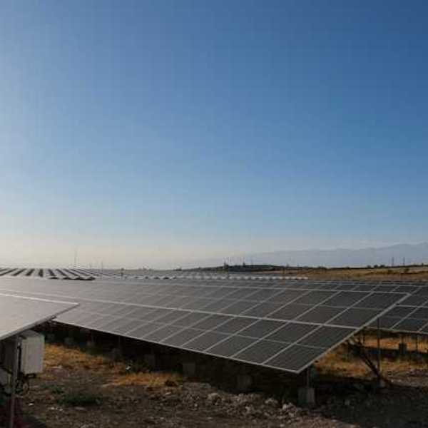 Solar panels stretched across a rocky landscape