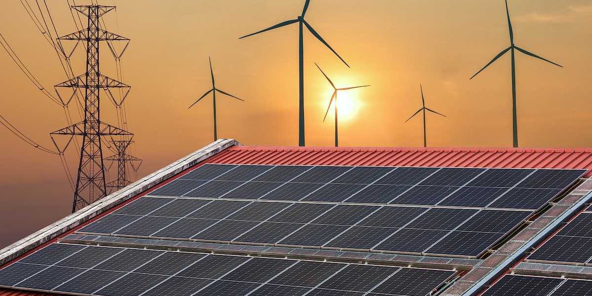 Solar power panels on a roof with wind turbines and powerlines behind