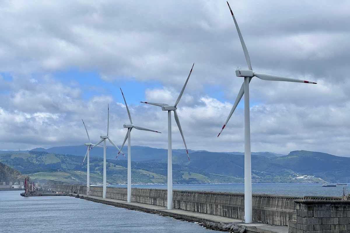 Spanish wind turbines operated by Acciona Energía, on the harbour wall at Bilbao.