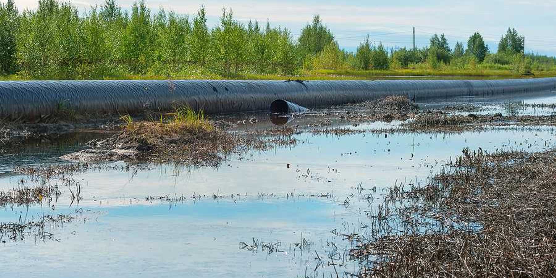 Spilled oil around a leaking oil pipeline.