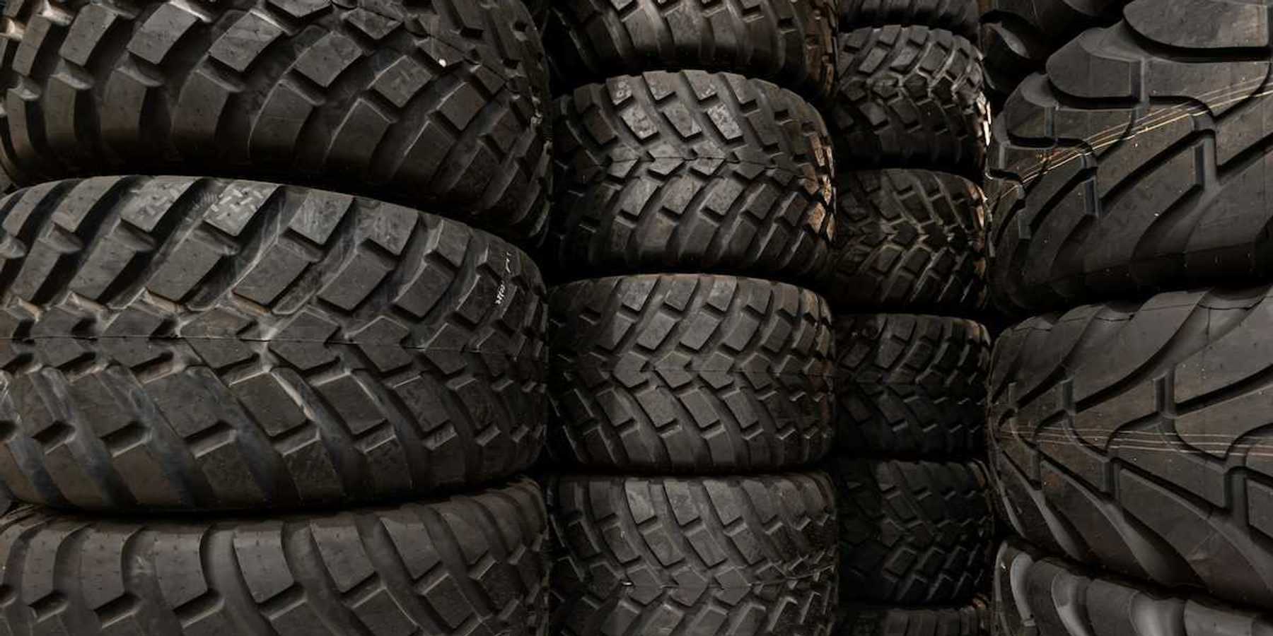 Stacks of car tires with varying tread patterns
