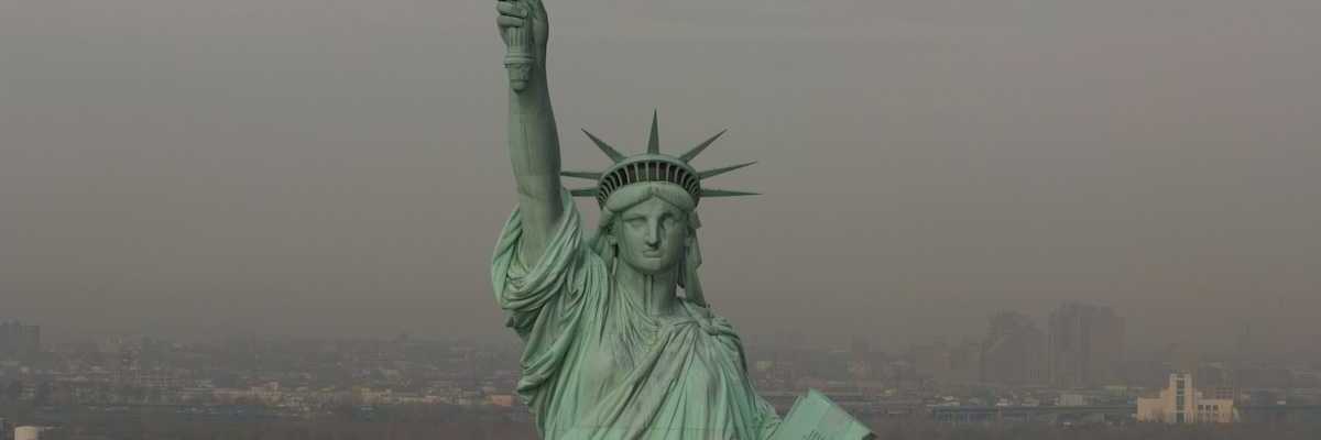 Statue of Liberty against a smoky, smoggy, sky and backdrop