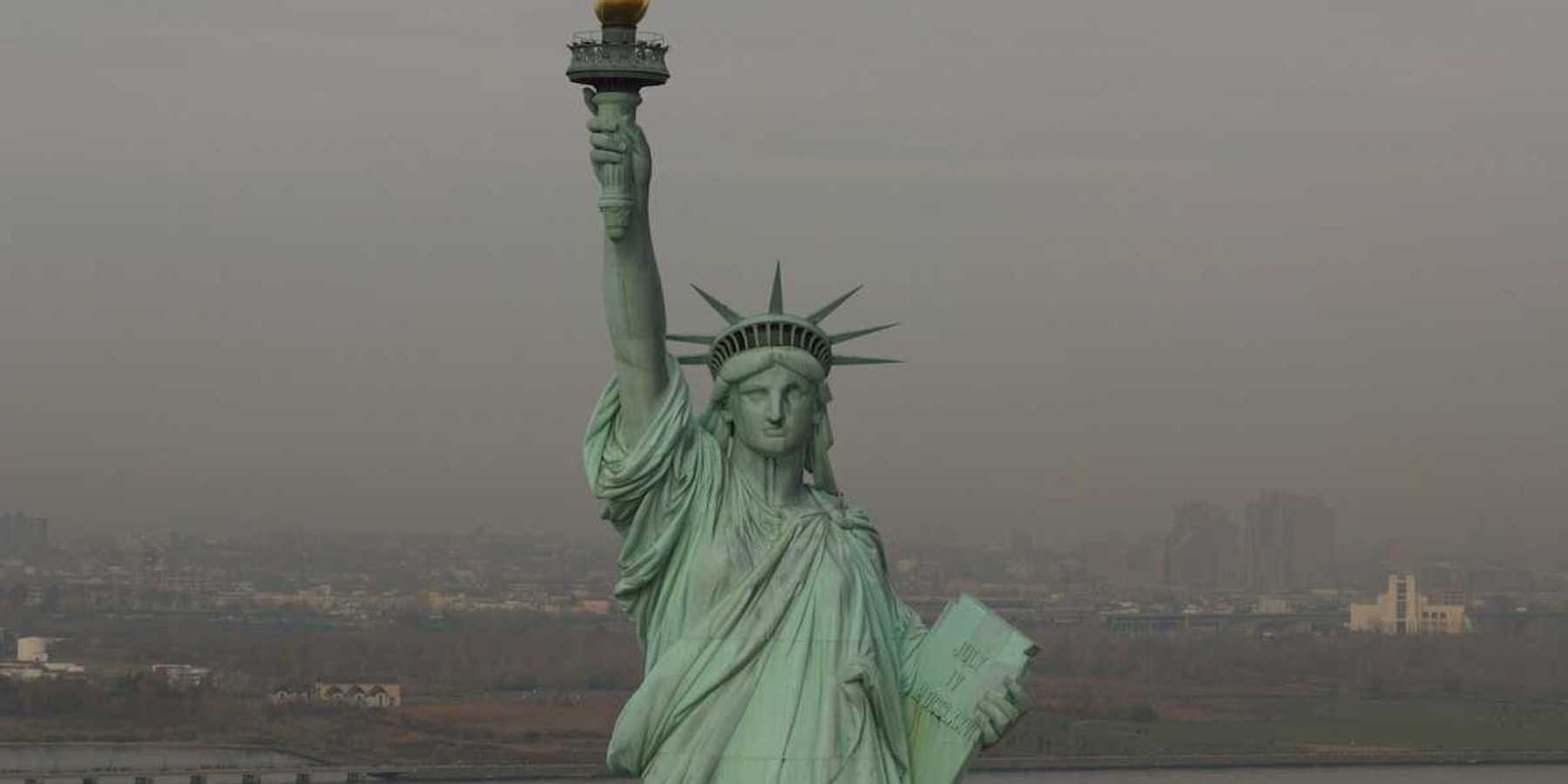 Statue of Liberty against a smoky, smoggy, sky and backdrop