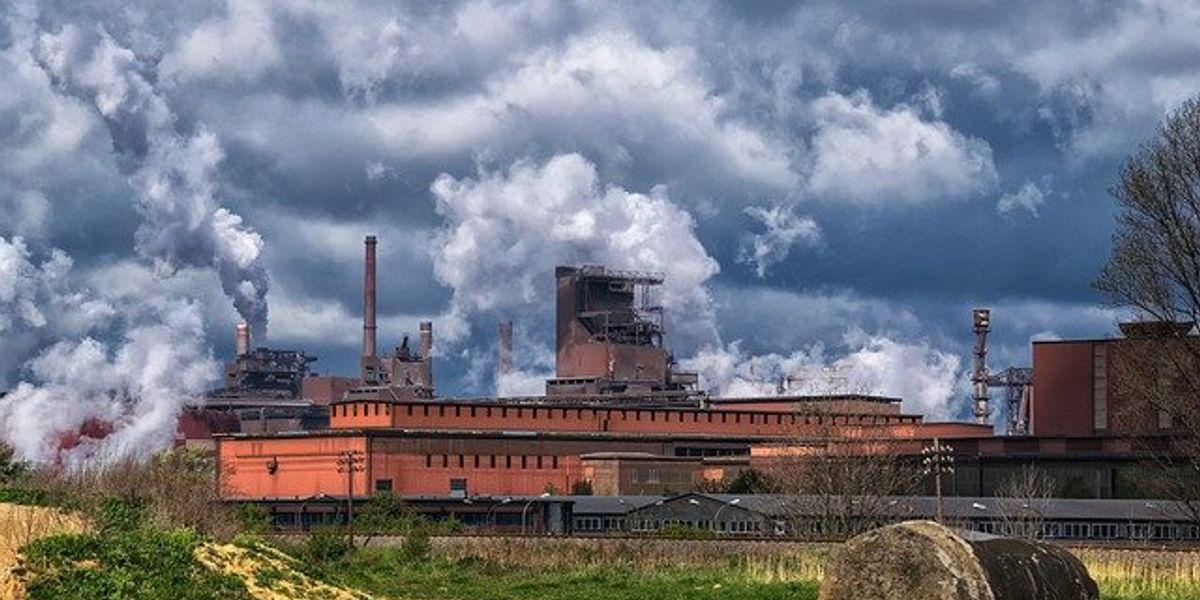 Steel mill under a cloudy sky.