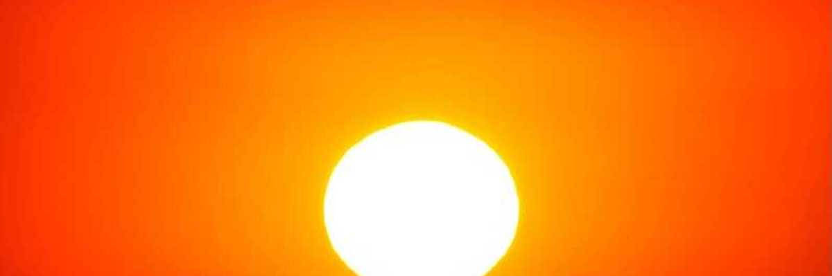 Sun shining through a red, hazy, heatwave