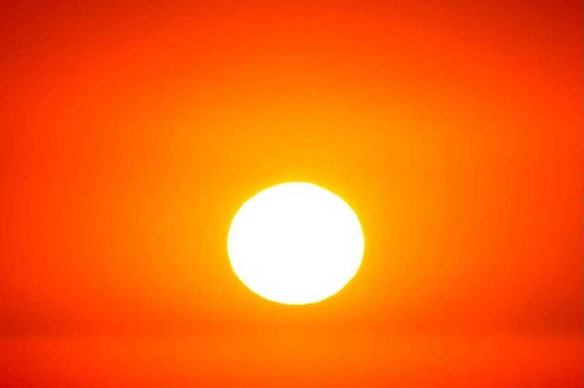 Sun shining through a red, hazy, heatwave