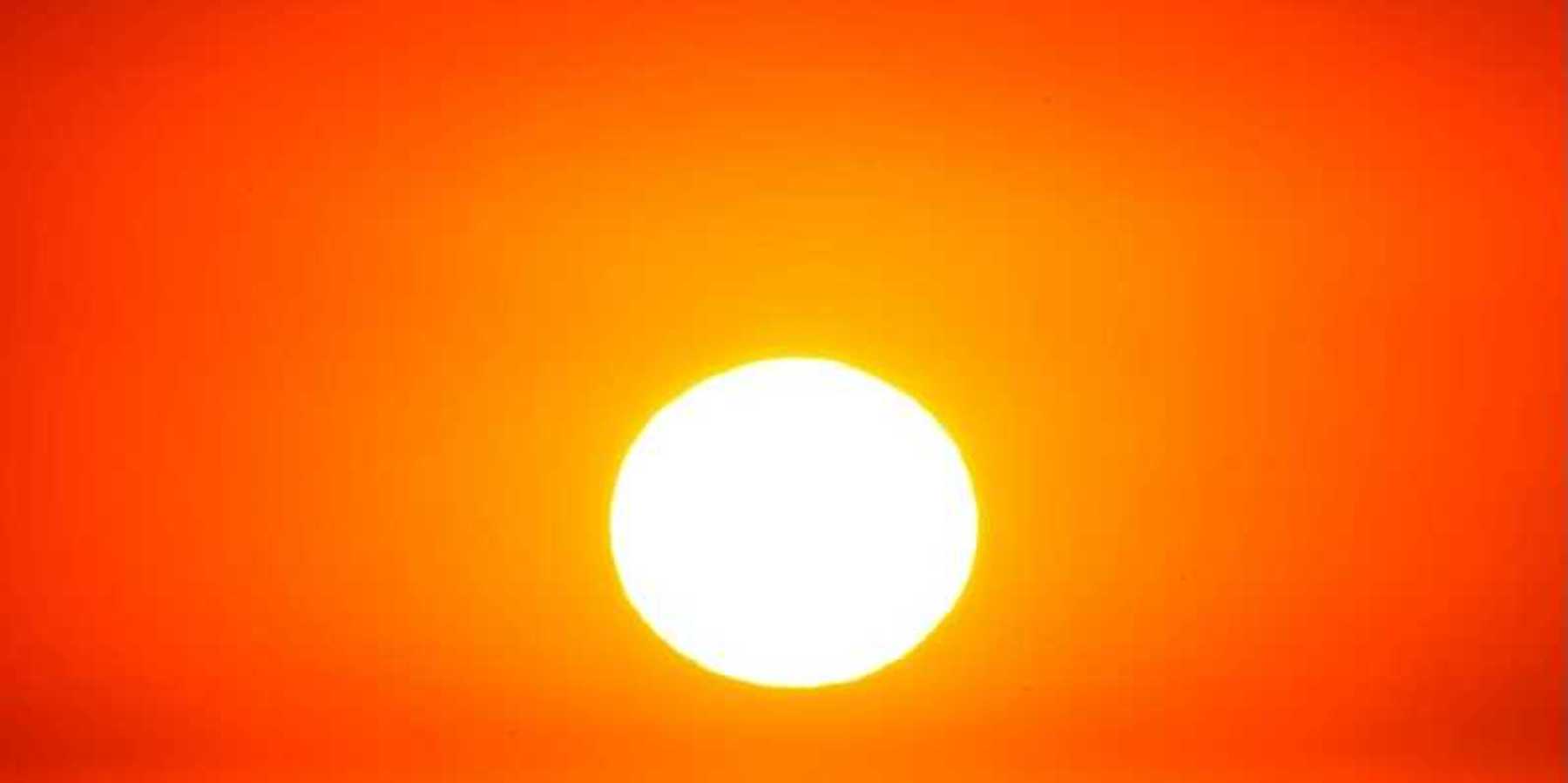 Sun shining through a red, hazy, heatwave