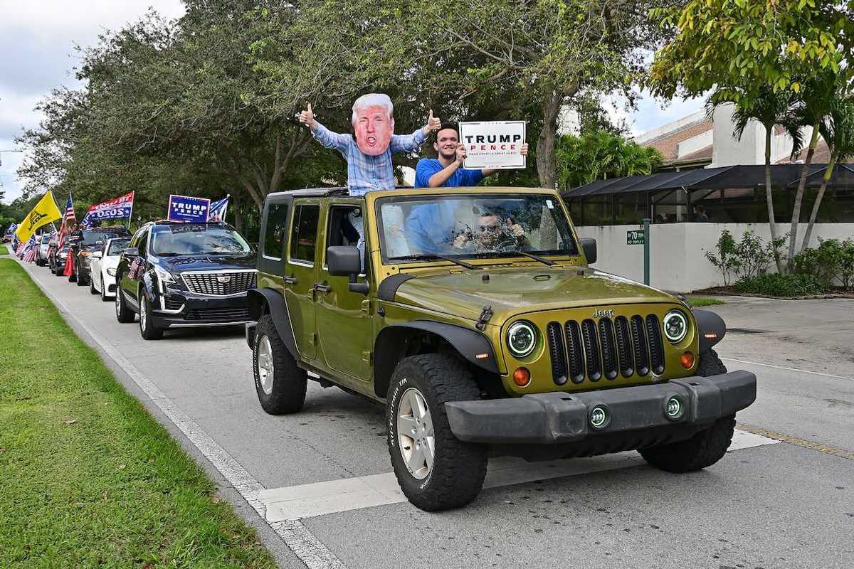 Supporters of President Donald Trump parade in cars and trucks in Miami, Florida