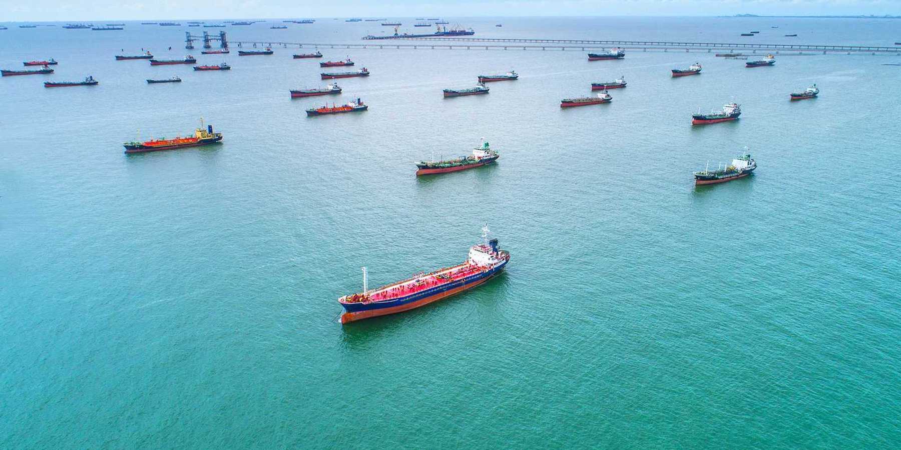 Tankers and cargo ships awaiting port access