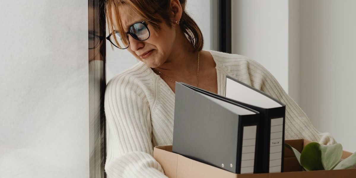 Tearful woman seemingly leaving job and carrying contents of her office