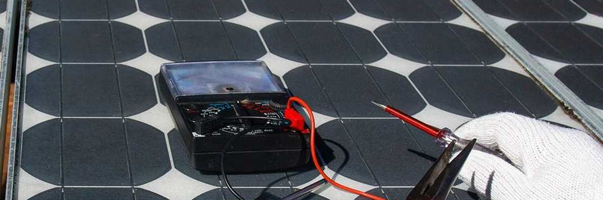 Technician wearing white gloves testing solar panel with multimeter