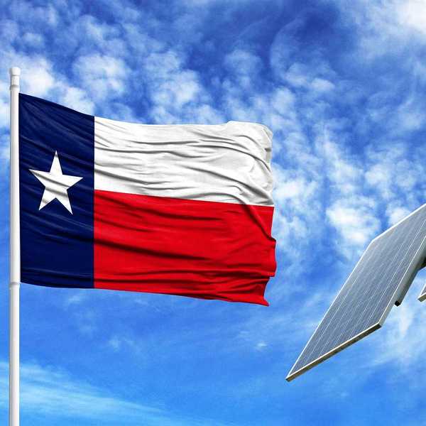 Texas flag flying adjacent to solar panel