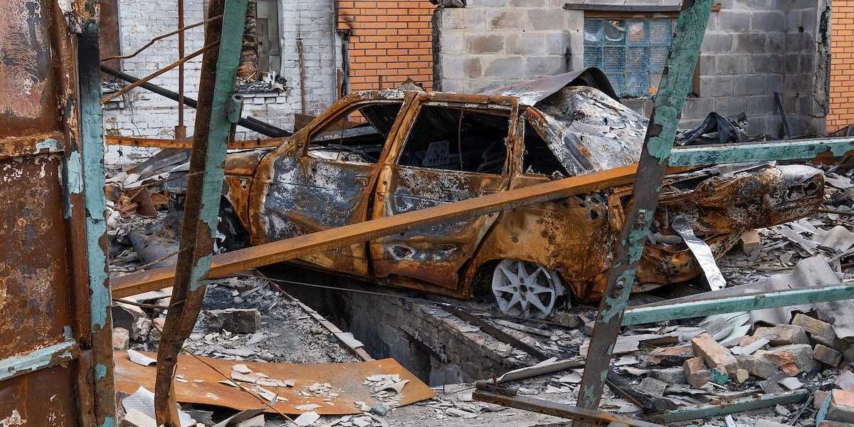 The car burned down in the garage of a house. Explosion and fire in the workshop. Soot and coal around.