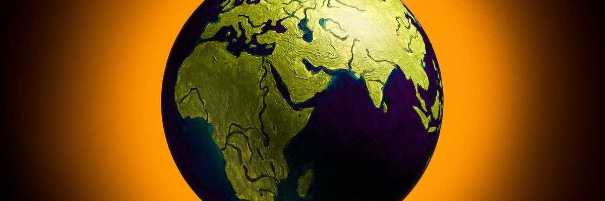 The concept of climate change. Planat earth on a fiery orange background.