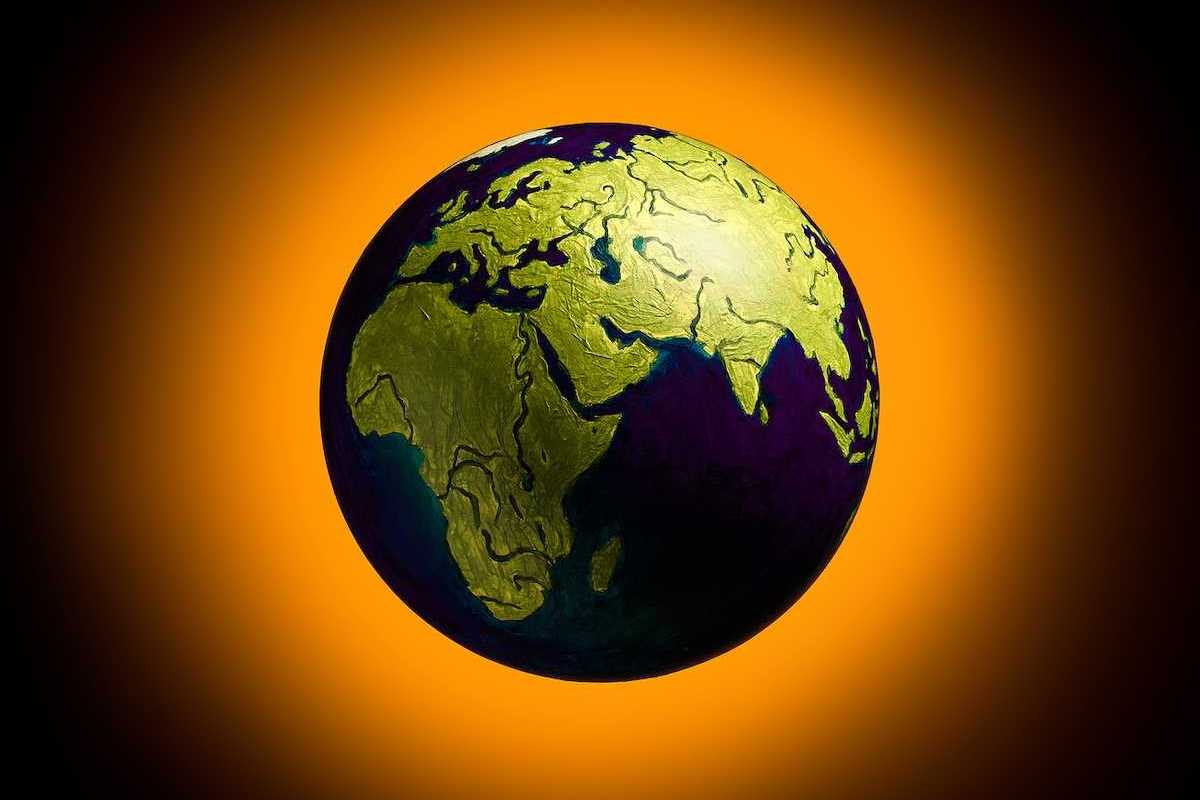 The concept of climate change. Planat earth on a fiery orange background.