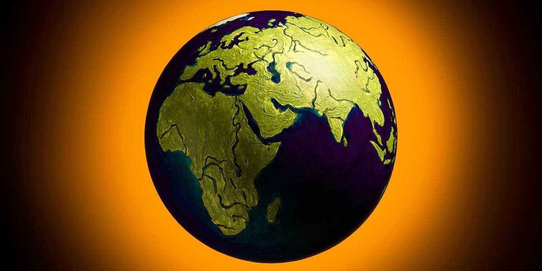 The concept of climate change. Planat earth on a fiery orange background.