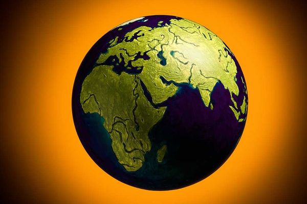 The concept of climate change. Planet earth on fiery orange background.