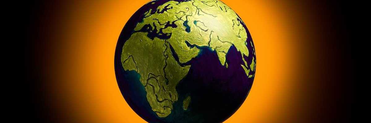 The concept of climate change. Planet earth on fiery orange background.