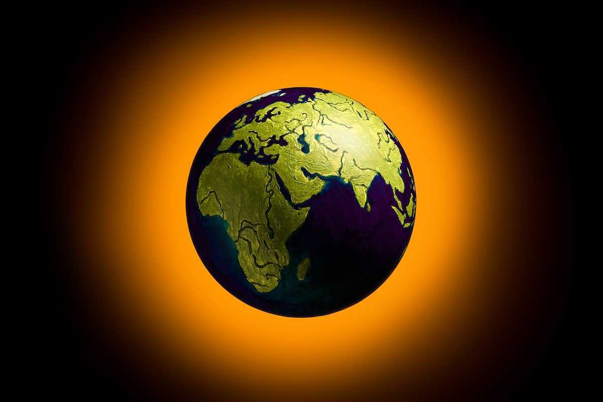 The concept of climate change. Planet earth on fiery orange background.