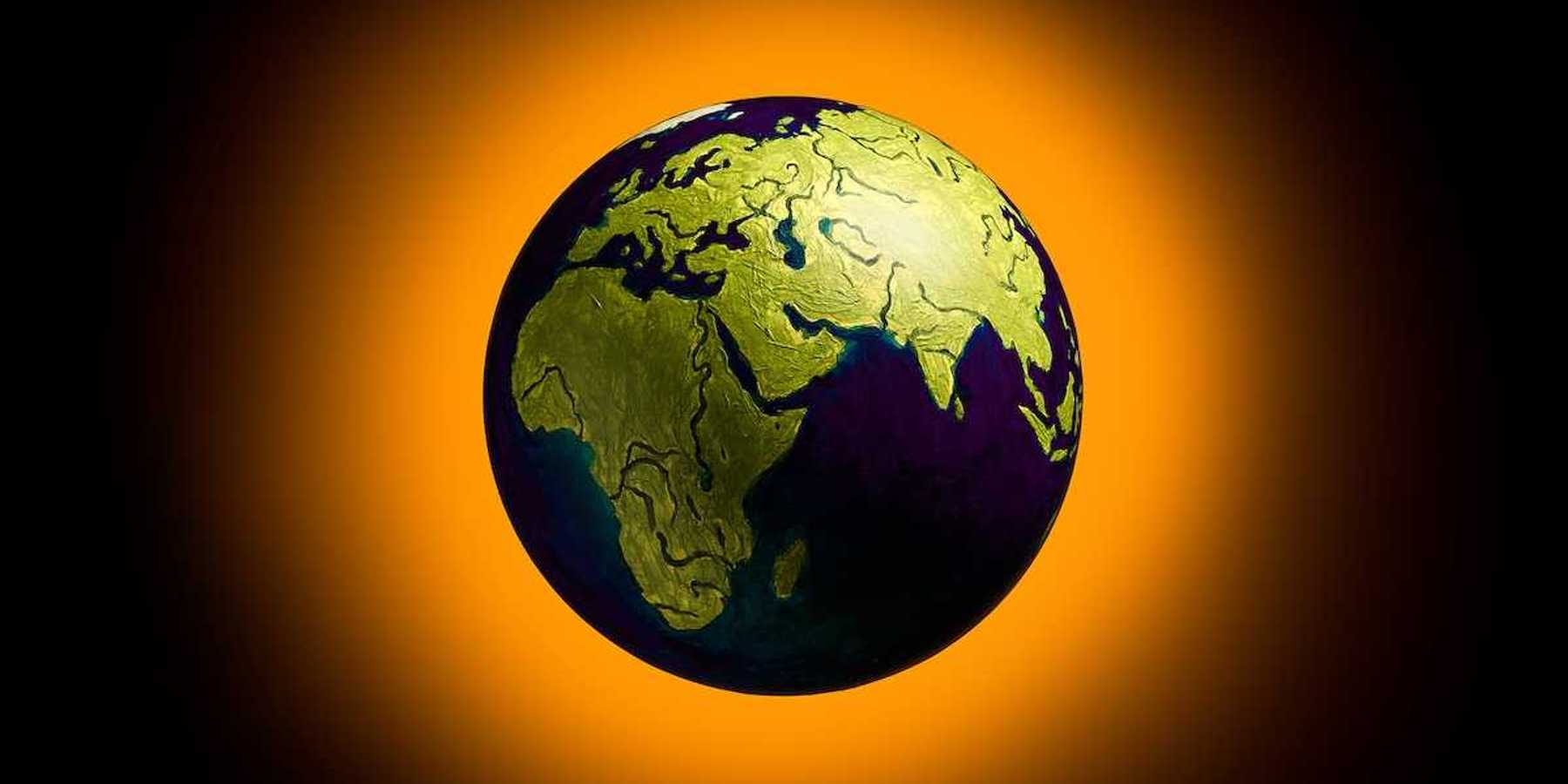 The concept of climate change. Planet earth on fiery orange background.