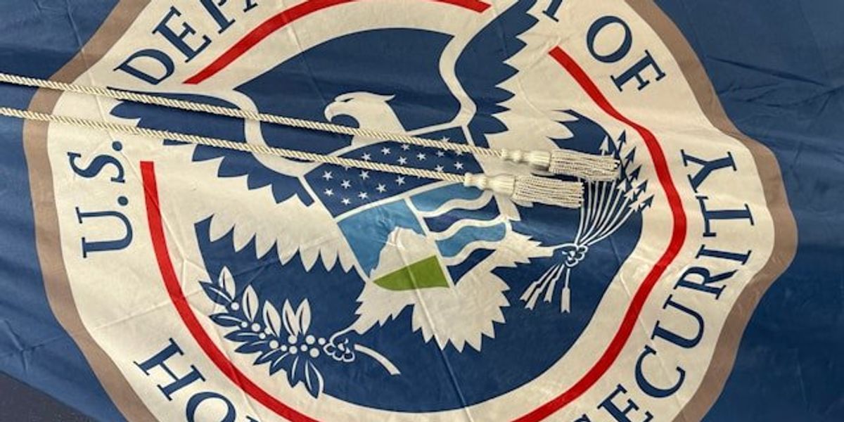 The flag of the Department of Homeland Security featuring a flying eagle grasping a branch and arrows in its claws.