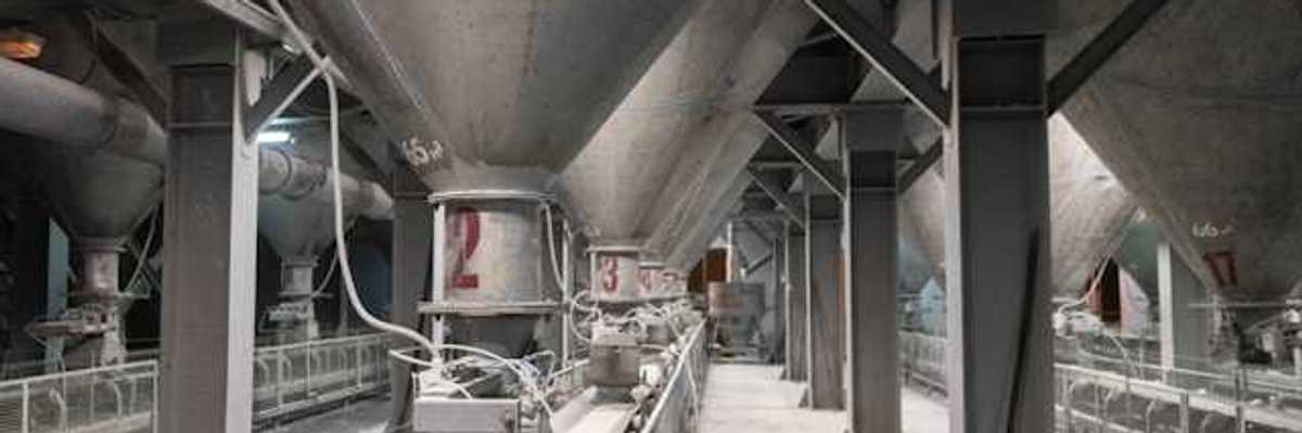 The interior of a cement plant with funnels leading to conveyer belts