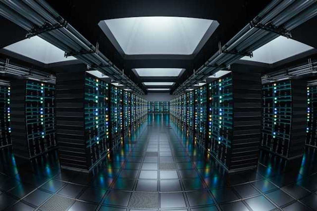 The interior of a data center with rows of black servers stretching into the distance