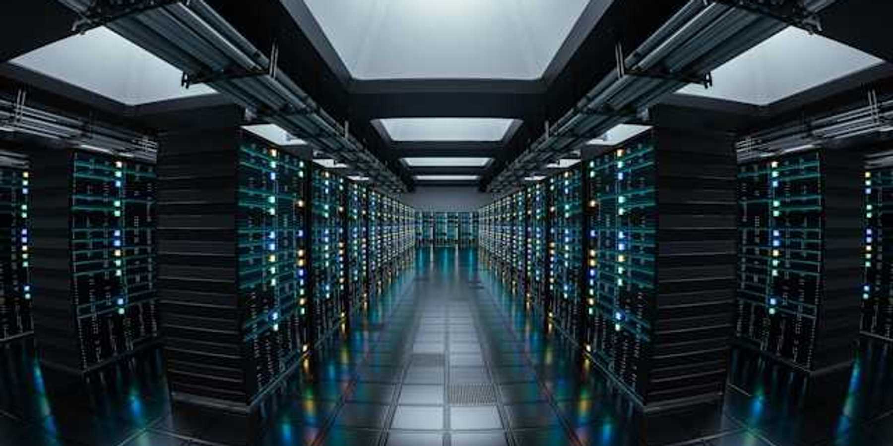 The interior of a data center with rows of black servers stretching into the distance
