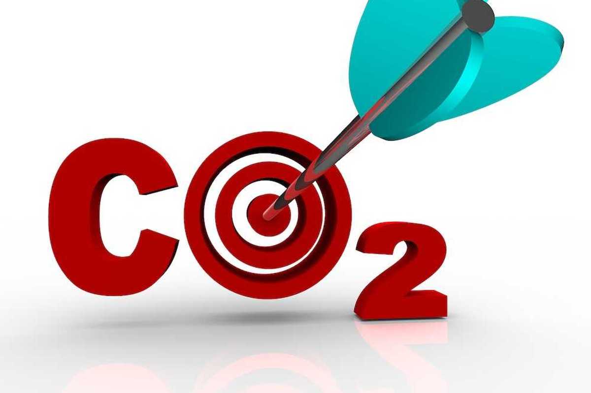 The letters CO2 representing Carbon Dioxide with a target bulls-eye in place of the O and an arrow hitting the middle of it, symbolizing a successful reduction of the harmful greenhouse gas