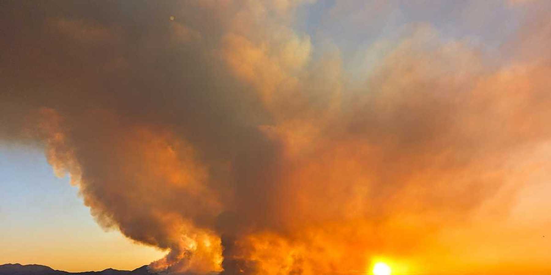 The massive Iron Fire seen from Genola, Utah, June 2026 againsta a setting sun